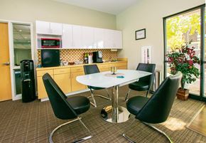 Olathe apartment for rent - A dining room with a white table and black chairs.