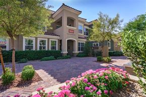 Las Vegas apartment for rent - A house with a driveway and pink flowers in front.