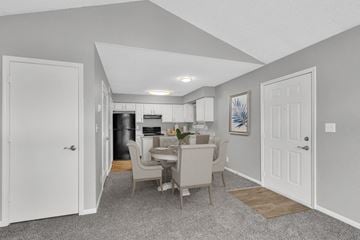 Kansas City apartment for rent - A kitchen with a dining table and chairs is visible through an open door.