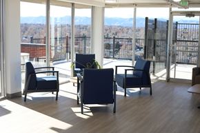 Denver apartment for rent - A room with a view of the cityscape through the windows.