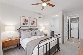 Johnstown apartment for rent - A bedroom with a bed, nightstand, and a ceiling fan.