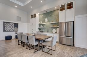 Apopka apartment for rent - a dining room with a wooden table and chairs and a stainless steel refrigerator