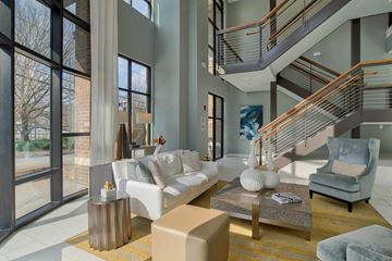 Atlanta apartment for rent - a living room with a white couch and a staircase