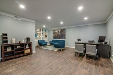 Houston apartment for rent - a living room with a desk and chairs and a couch
