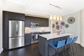 Modelhomes-french-door refrigerator, kitchen islands and quartz countertops in chef-inspired kitchens