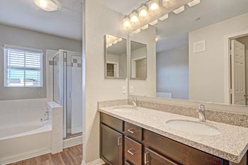 Modelhomes-granite counters and custom cabinetry in bathrooms