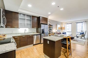 Boston apartment for rent - a kitchen and living room with a bar and a dining table