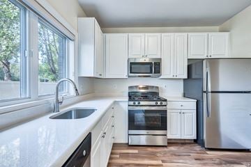Edgewater apartment for rent - a kitchen with white cabinets and stainless steel appliances