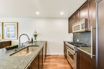 Modelhomes-kitchen with granite countertops and espresso cabinetry