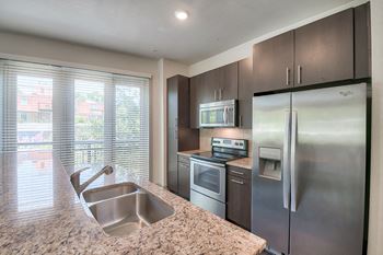 Modelhomes-granite countertops with natural stoneback splashes