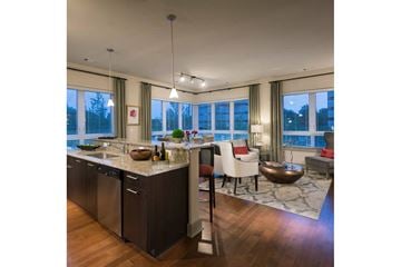 Cambridge apartment for rent - an open kitchen and living room with a table and chairs