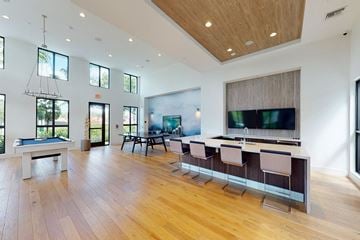 Plantation apartment for rent - a large living room with a bar and a television