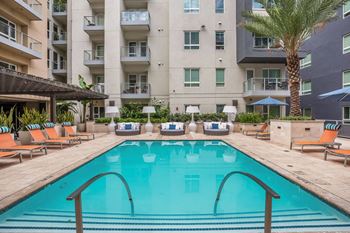 Amenities-resort-style swimming pool with sundeck cabanas