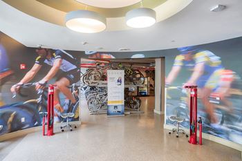 Amenities-bike lounge equipped with repair stations, seating and tvs