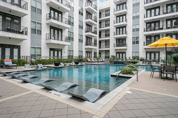 Resort-style swimming pool with expansive tanning areas