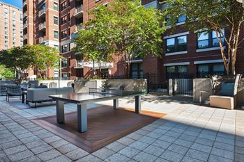New courtyard lounge with fire pit, bbq grills, and outdoor games