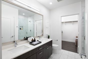 A bathroom with a large mirror and two sinks
