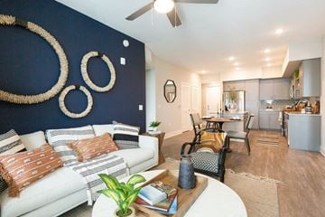 Plantation apartment for rent - a living room with a blue accent wall and a white couch