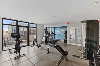 Fitness center featuring peloton bike & rowing machine
