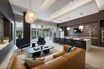 Los Angeles apartment for rent - a living room with a couch and a table with chairs