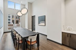Atlanta apartment for rent - a dining room with a long table and chairs and a large window