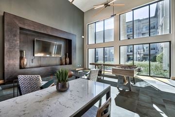 Austin apartment for rent - a living room with a table and chairs and a piano