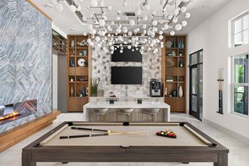 Game room with pool table and tvs