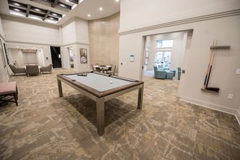 Billiards room with high-top seating and large flat screen tvs
