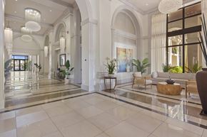 Doral apartment for rent - A spacious, well-lit lobby with a marble floor and elegant furniture.