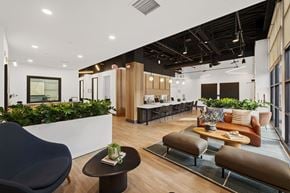 Pasadena apartment for rent - A modern office space with a variety of seating options and plants.