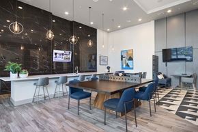 Plano apartment for rent - A modern dining lounge area with a wooden table and blue chairs at Metro West, Texas, 75024.