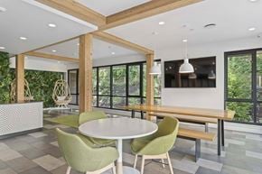 Kirkland apartment for rent - A modern dining room with a white table and green chairs.