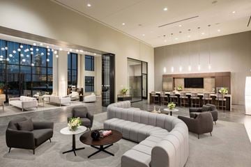 Houston apartment for rent - A modern living room with a large grey sofa and a coffee table.