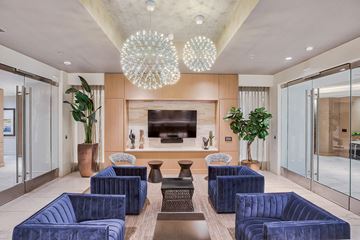 Los Angeles apartment for rent - a living room with blue chairs and a television