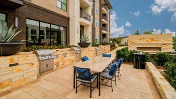 Courtyard with expansive lawn, firepit, and grilling areas