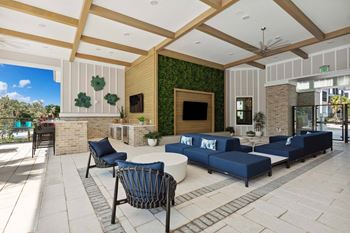 Covered open-air clubroom with seating, tv and bar