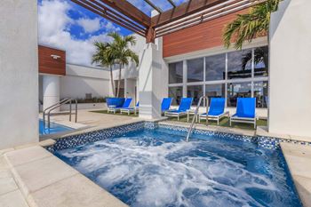 Rooftop infinity pool and hot tub with tons of seating options and lounge areas