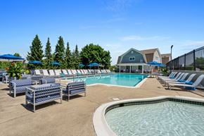 Waltham apartment for rent - our resort style swimming pool is surrounded by lounge chairs and umbrellas