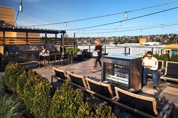 Rooftop grilling area with fireplace and 360 views