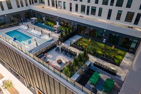 Denver apartment for rent - A patio with a pool and lounge chairs at Windsor 3000 Huron, 3000. N. Huron Street, Denver, CO 80202.