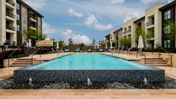 Infinity-edge pool with relaxing cabanas and lounge seating