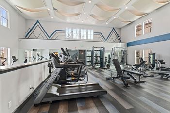 Two-story fitness center with cardio machines and free weights