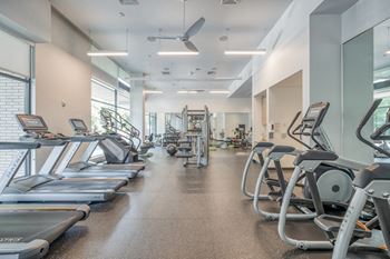 Hiit inspired fitness studio with trx bands, weight stations and cardio equipment