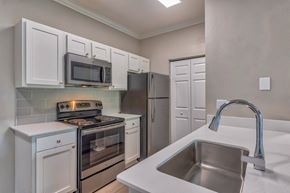 Charlotte apartment for rent - A kitchen with white cabinets and stainless steel appliances