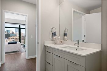 Oversized frameless mirrors and tile flooring