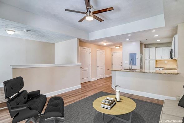 Atlanta apartment for rent - a living room with two black chairs and a ceiling fan