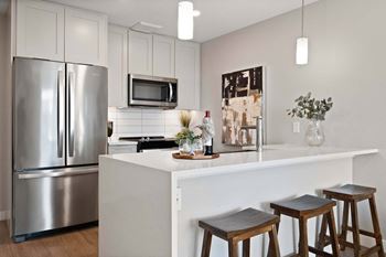 Chef-inspired kitchens with quartz counter tops and tile backsplash