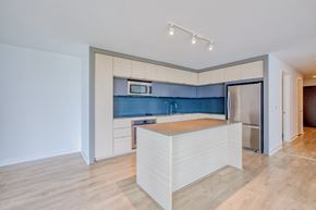 Bethesda apartment for rent - Modern kitchen with islands, light cabinetry, and dark backsplash