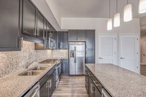 Houston apartment for rent - a kitchen with granite countertops and stainless steel appliances