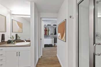 Quartz countertops and large frameless mirrors in bathrooms